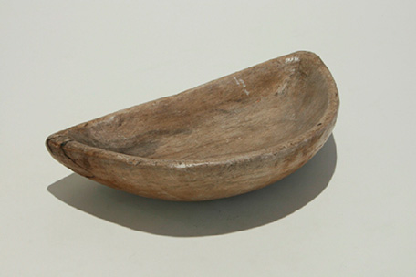 The fire was Inuit woman's responsibility. The Qulleq is a Flat container made of soapstone. Brown color on white background.