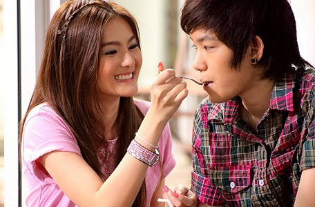 Girl feeding her tomboy girl, like a traditional couple girl boy.