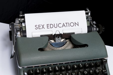 A typewriter in which the text Sex Education appears, whish is necessary to understand Sexual Identity